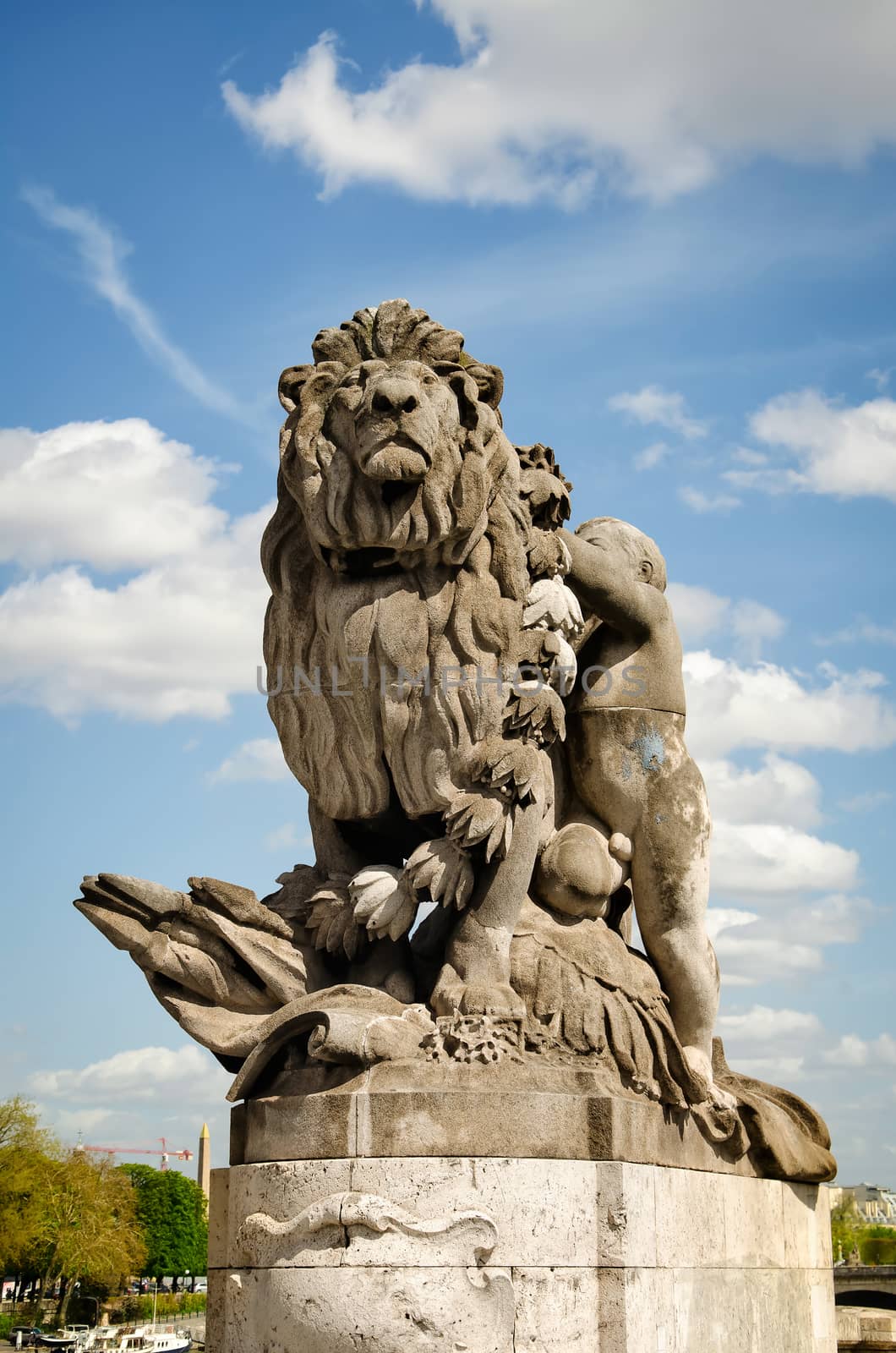 Paris, France - April 18, 2013:View of sculpture Lion steered by a child (Lion conduit par un enfant) at Alexander III bridge. Copy space in sky.
