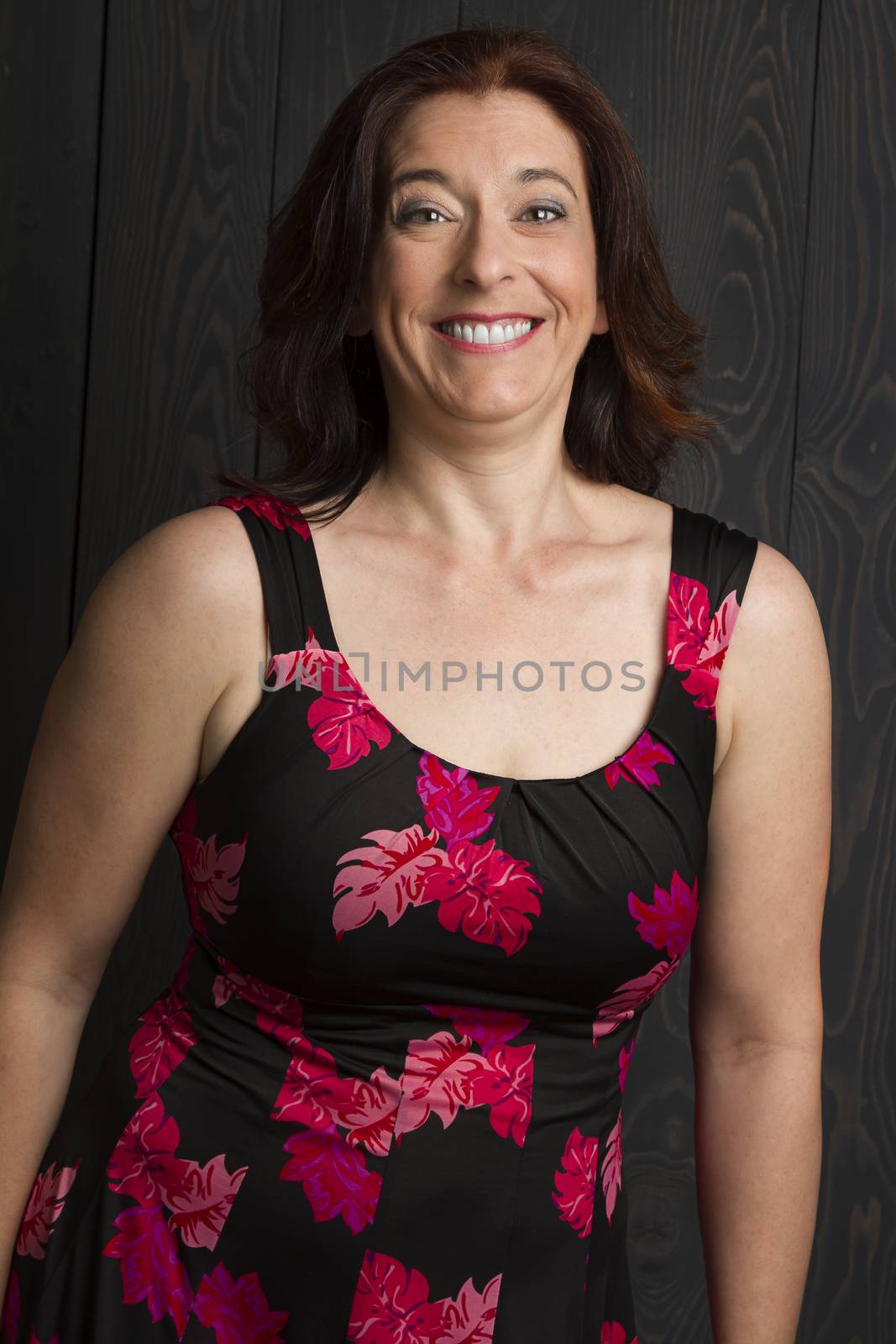 forty year old woman wearing a summer dress, with a happy surprise expression