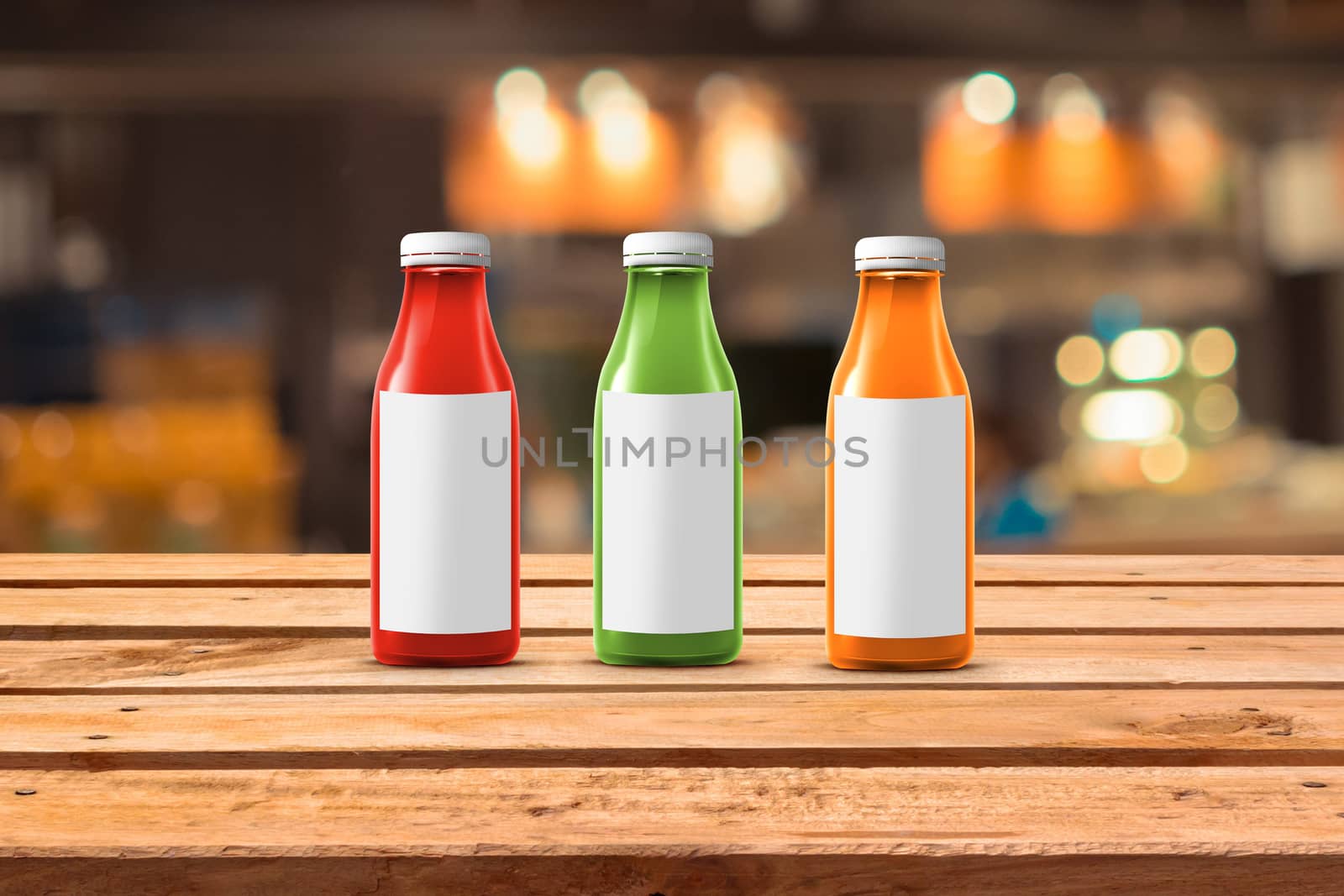 three multicolored bottles of juice are on the counter