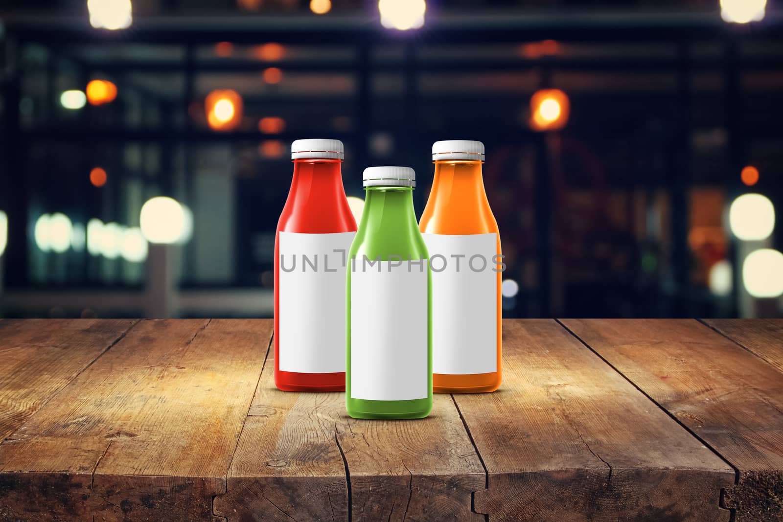 three multicolored bottles of juice are on the counter