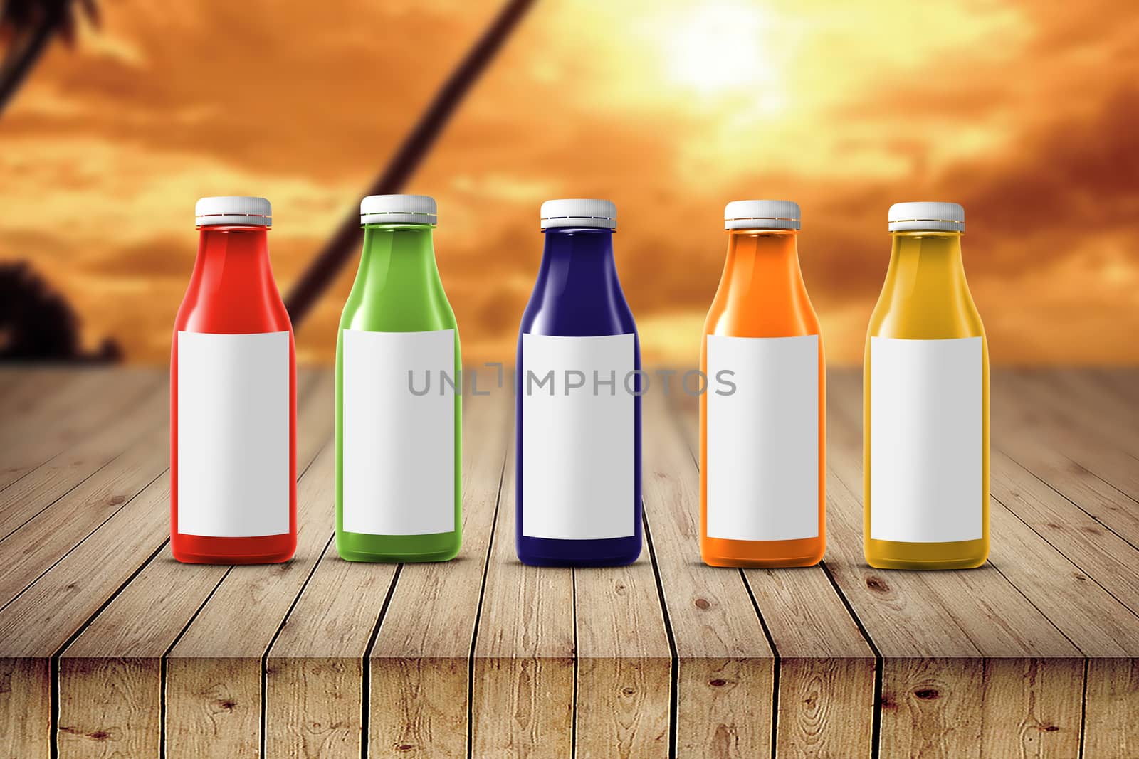 five multicolored bottles of juice are on the counter