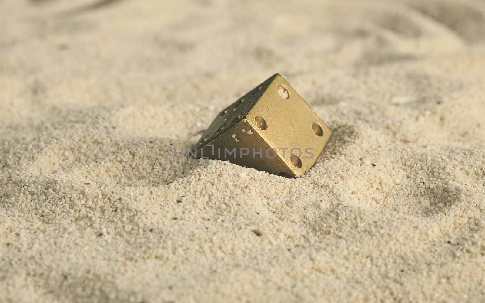 some dices  buried in the sand dunes