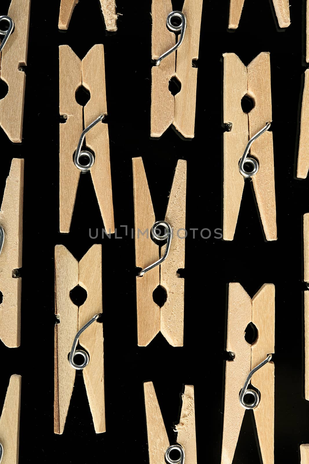 Group of wooden clothes pin in black background by nachrc2001