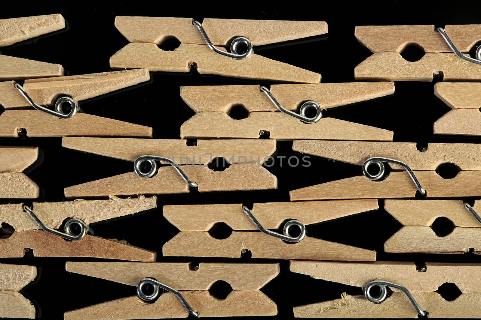 Group of wooden clothes pin in black background