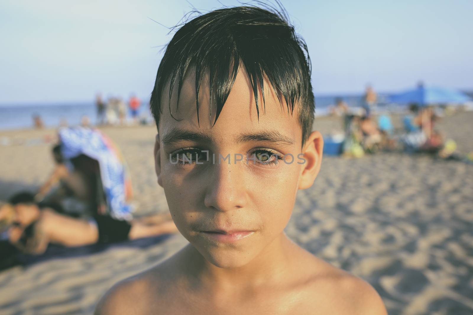 green eyes little boy on the beach