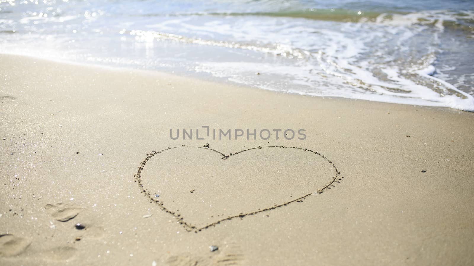 Love heart sign draw on the sand beach by nachrc2001