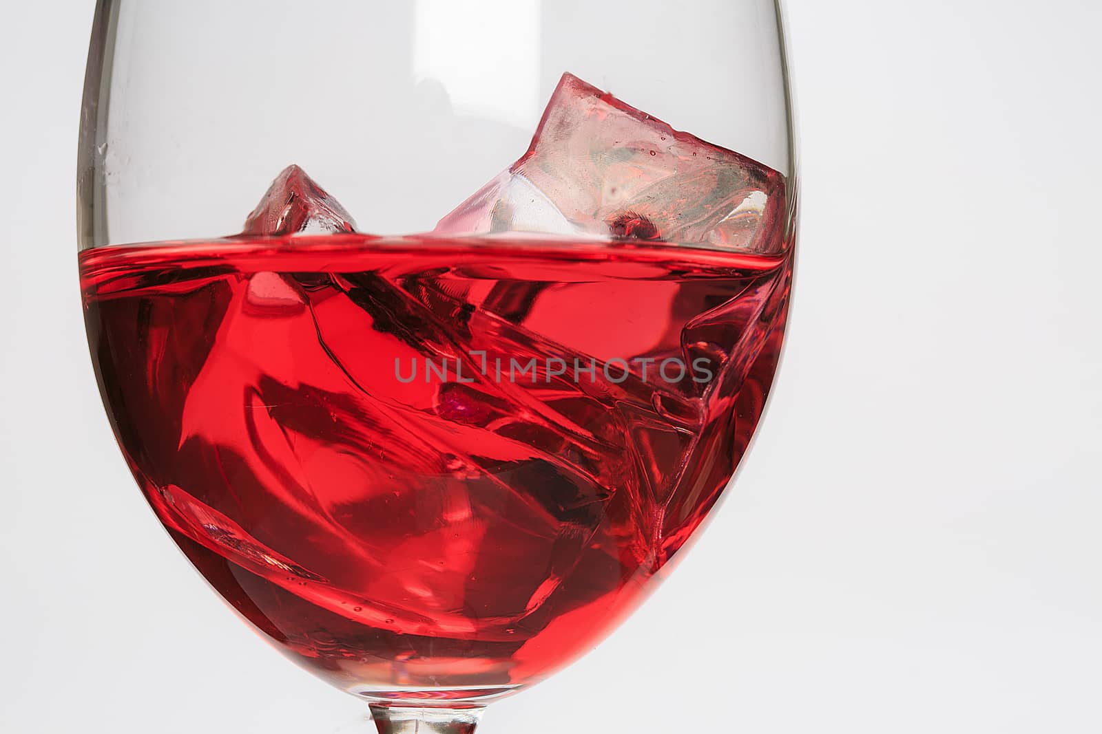 Glass cup with red liquid and ice by nachrc2001