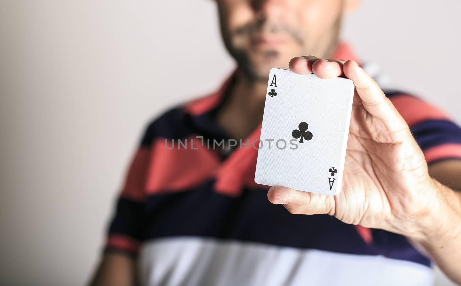 Man showing playing card in his hand