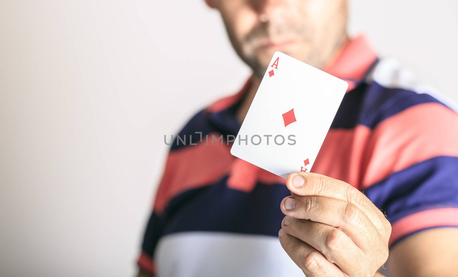 Man showing playing card in his hand