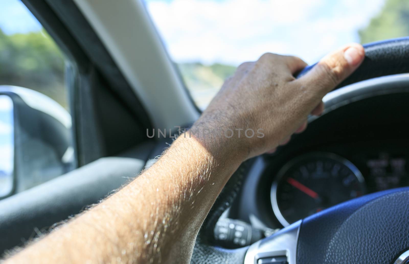 hand of Man driving his car