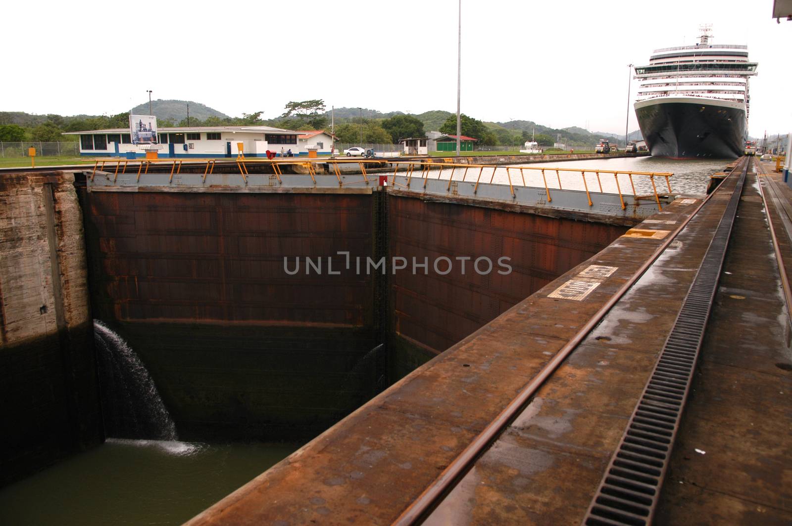 Cruise ship passing trough Panama canal on cloudy day