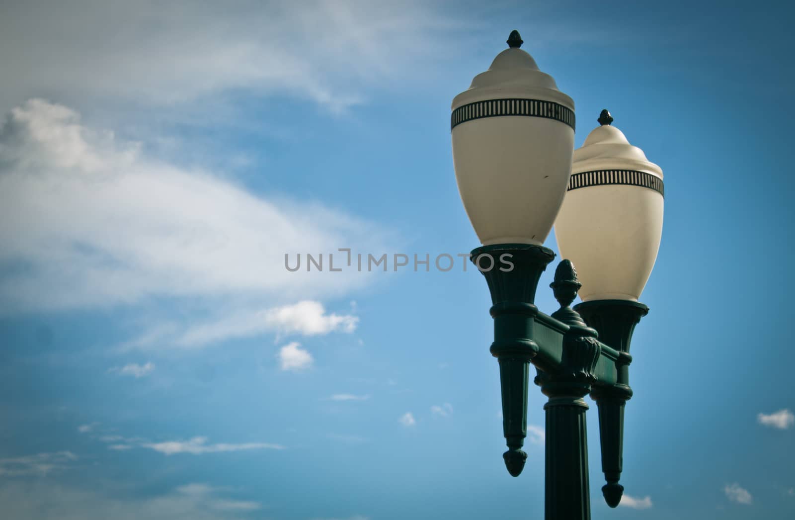 Classic lighting pole against blue sky by gigiobbr