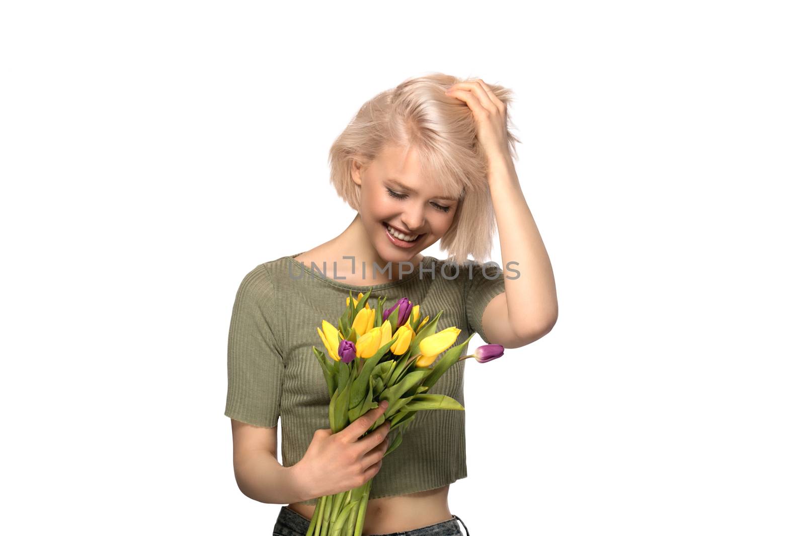 Beautiful excited smiling woman holding a bouquet of tulips isolated on white background