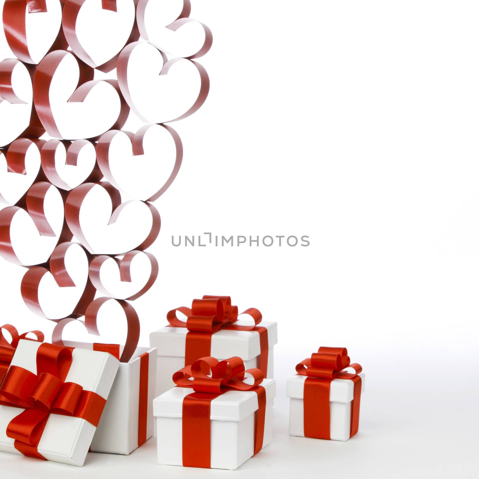 White boxes with red ribbons and decorative hearts isolated on white background