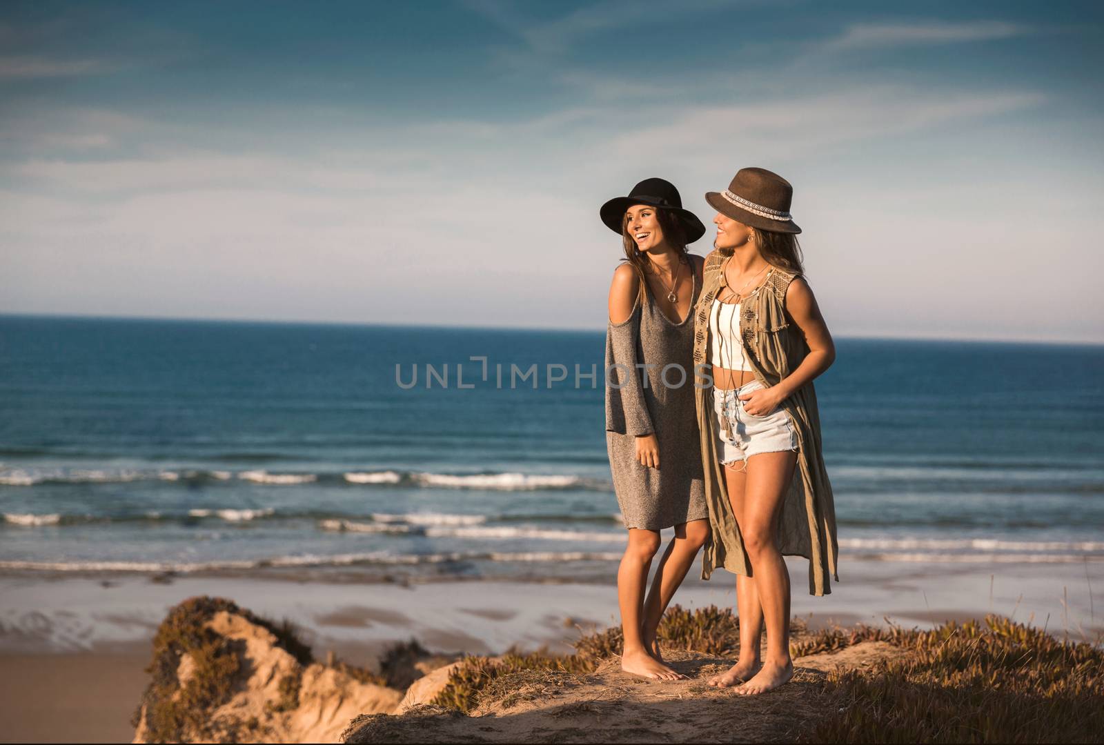 Two best friends near the coastline having fun on a beautiful summer day