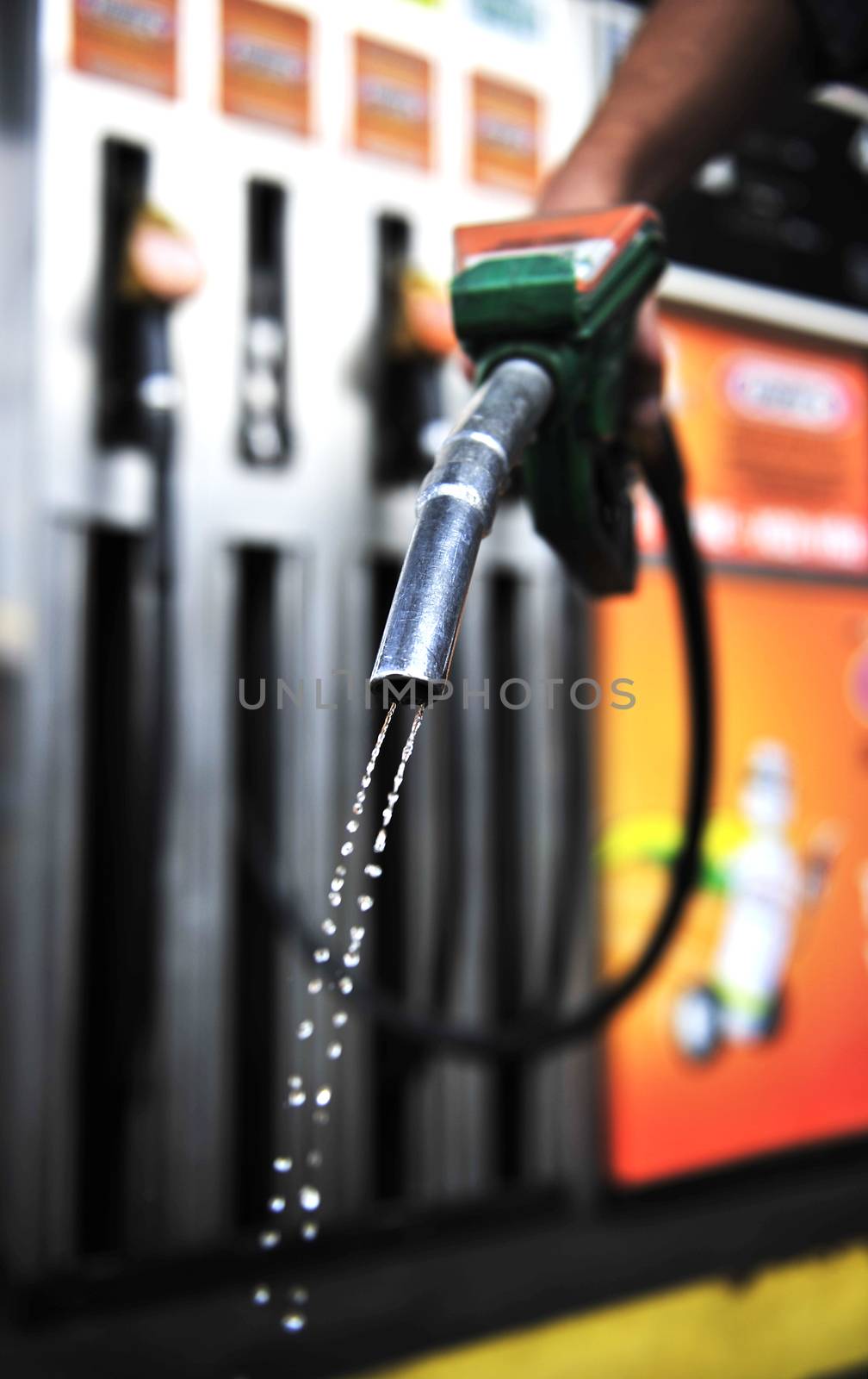 Man holding Gasoline pistol at gas station