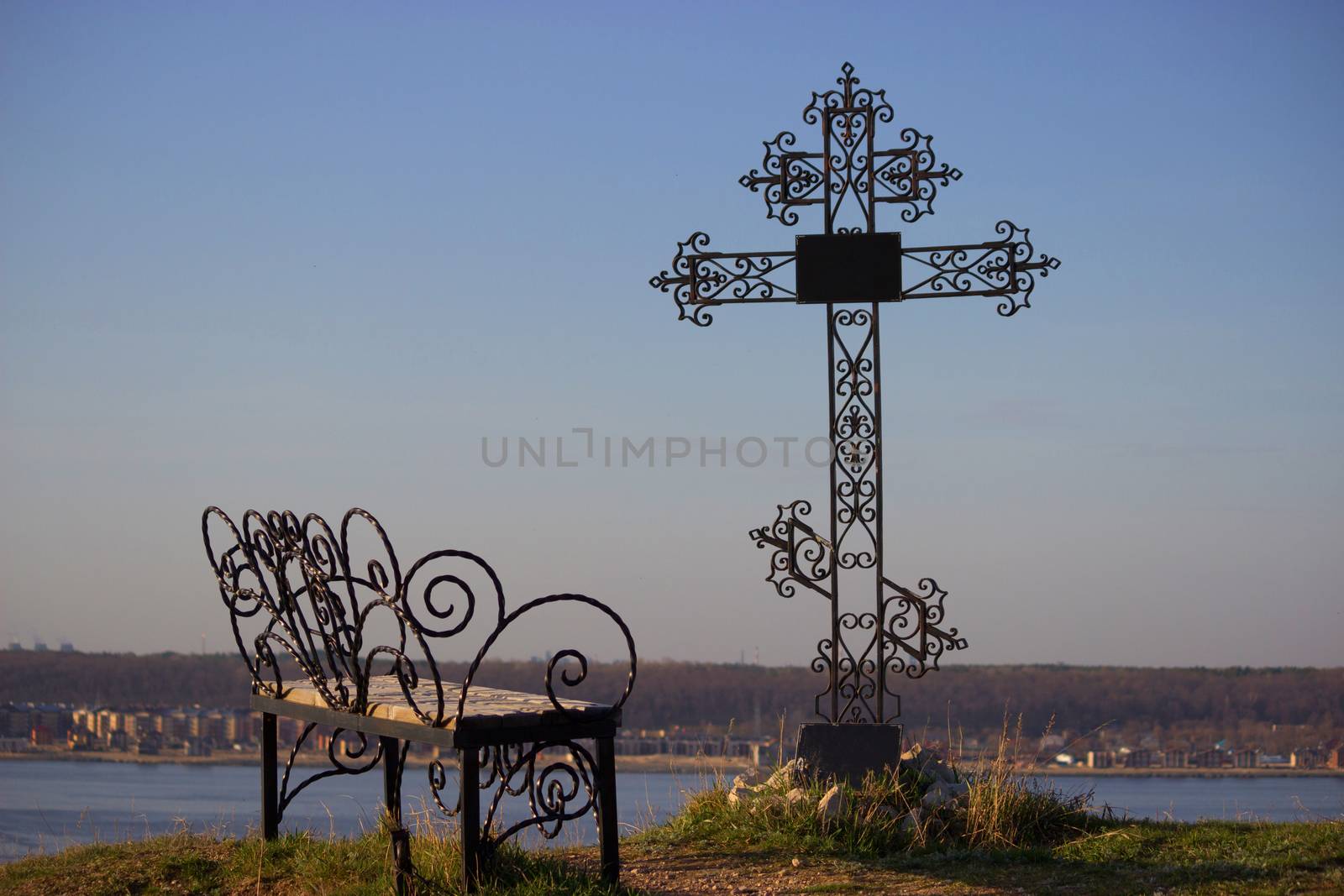 bench and metal ortodox cross. sorrow and sadness concept