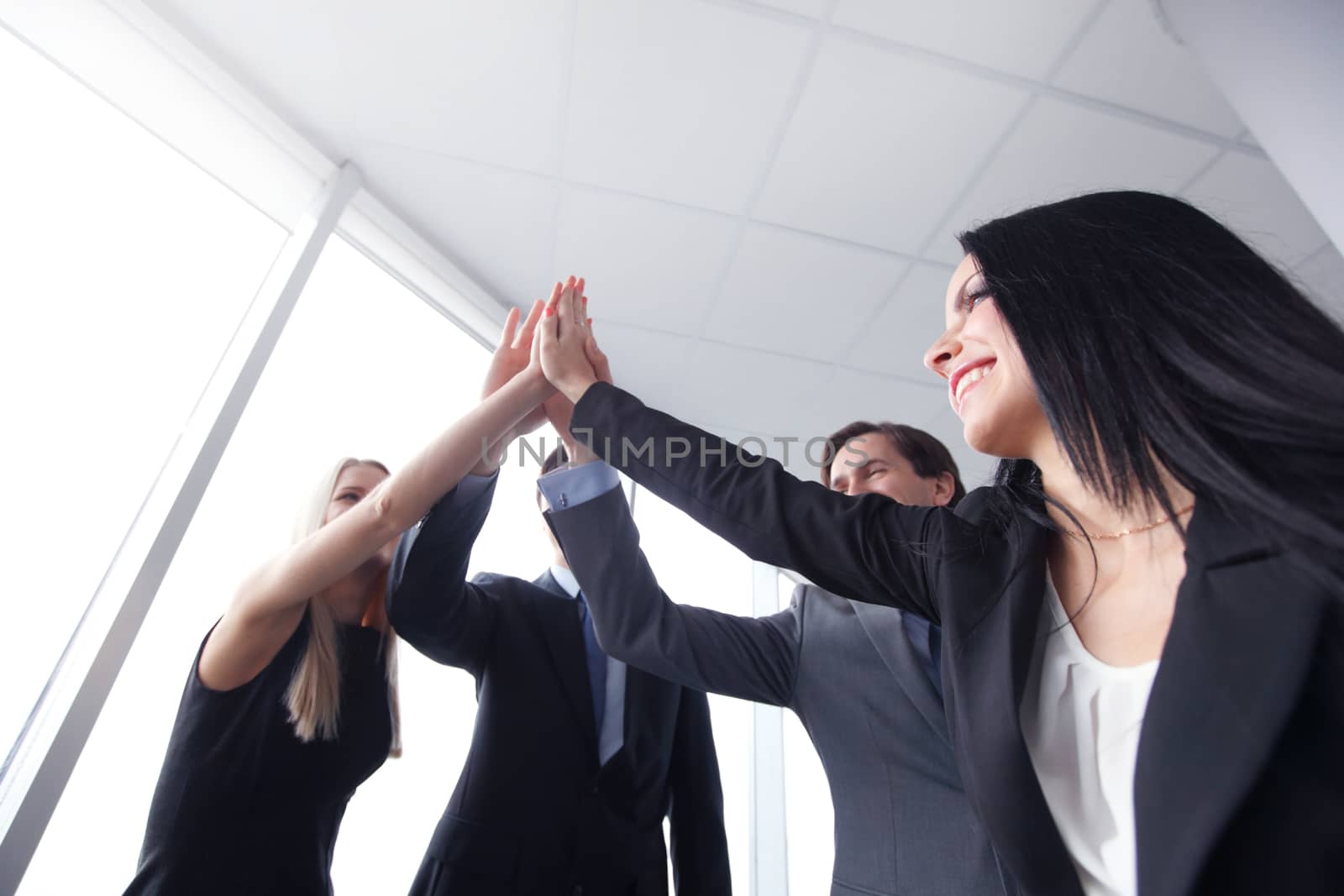 Happy business people hands giving high five 