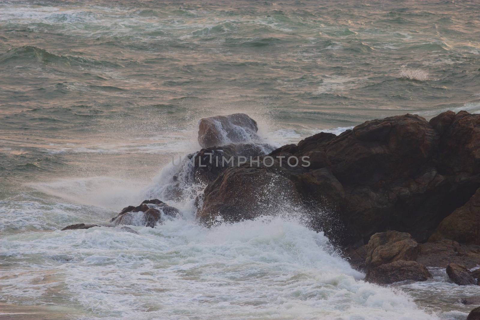 storm on the ocean. huge waves and rocks. dander for ships concept