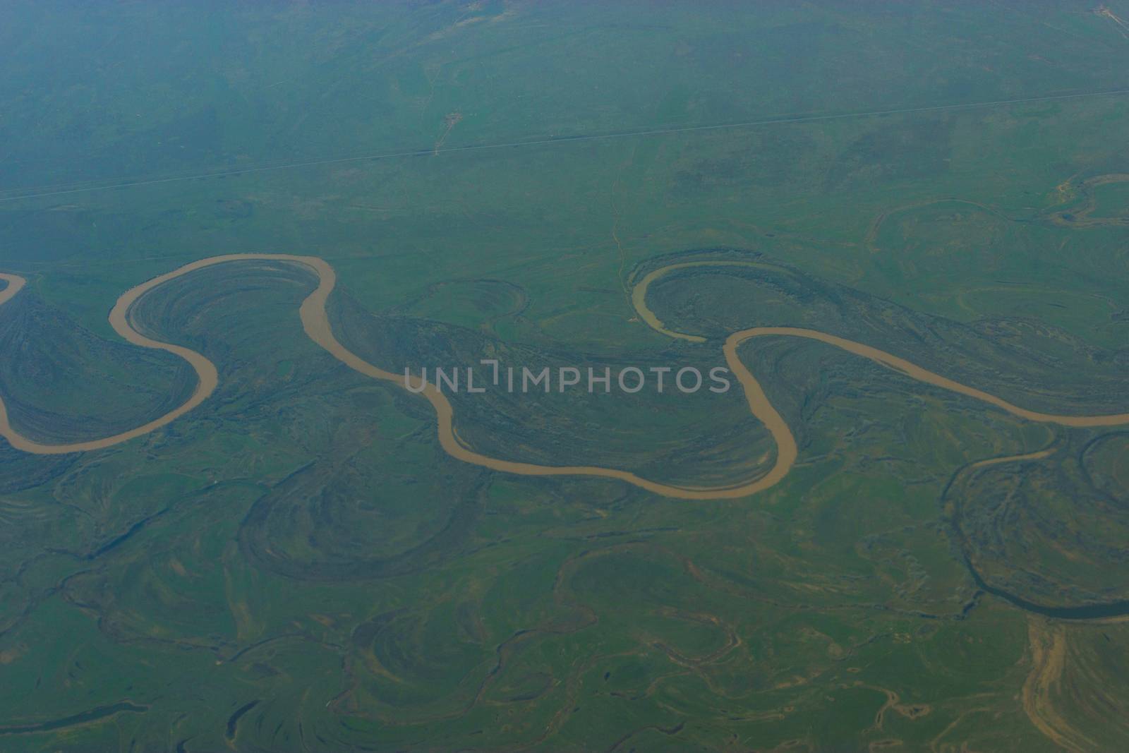 top view on a river fron a plain