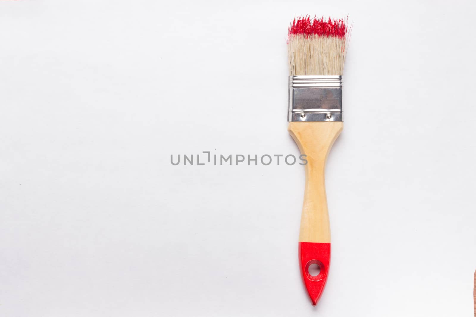 construction brush with red paint. copy space