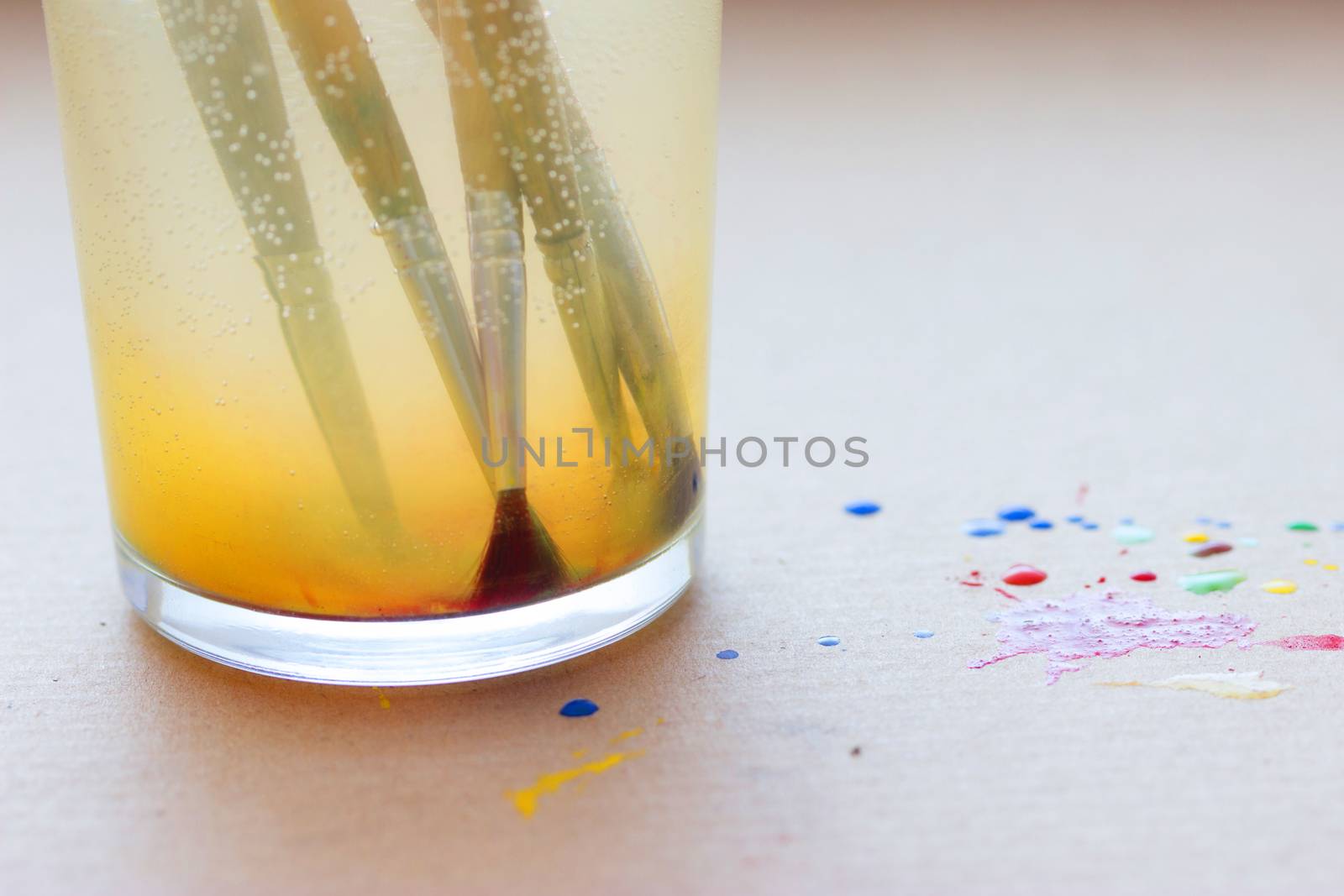 paintbrushes in glass with water. artistic concept