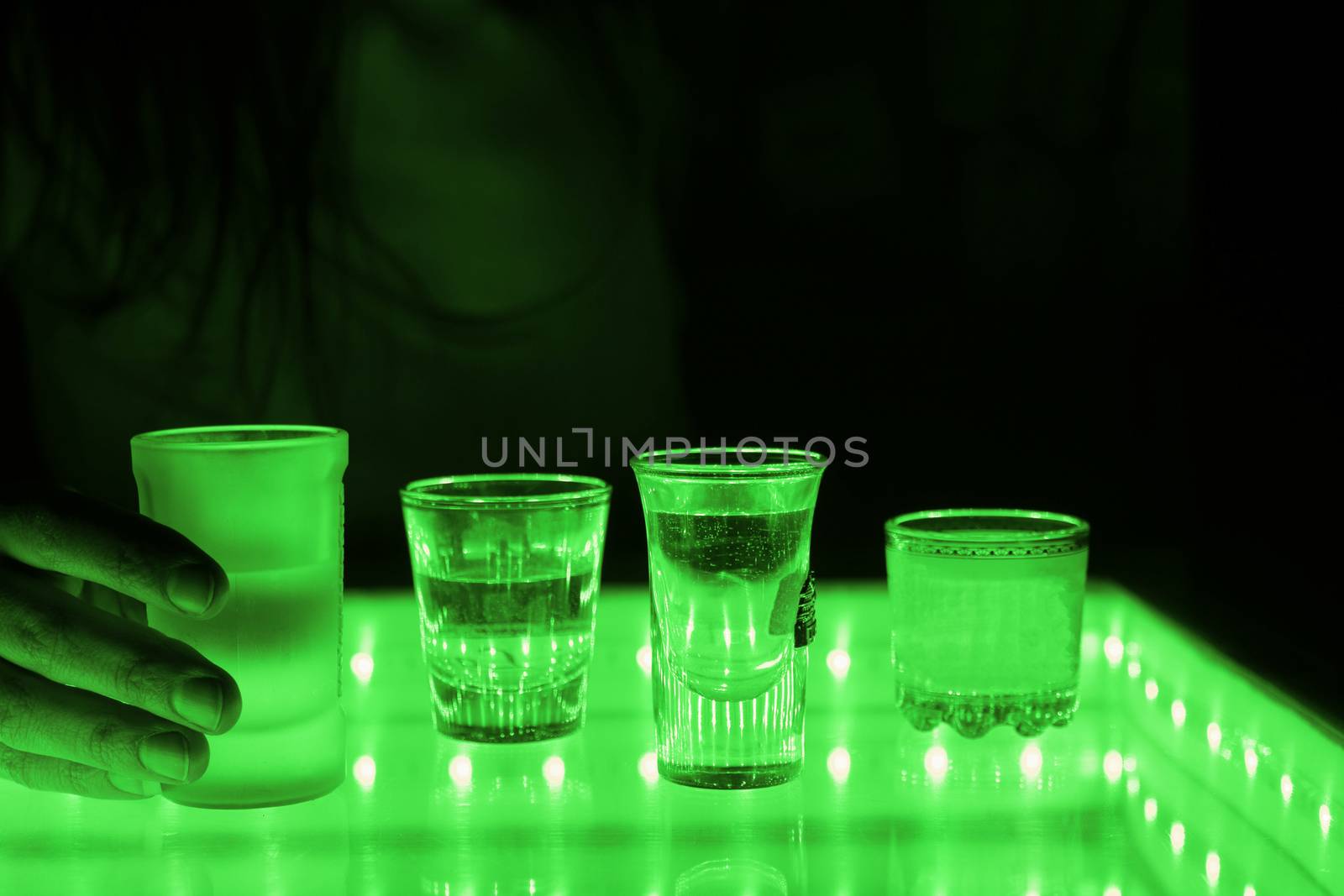 woman in a bar or club with glass of alcohol drink