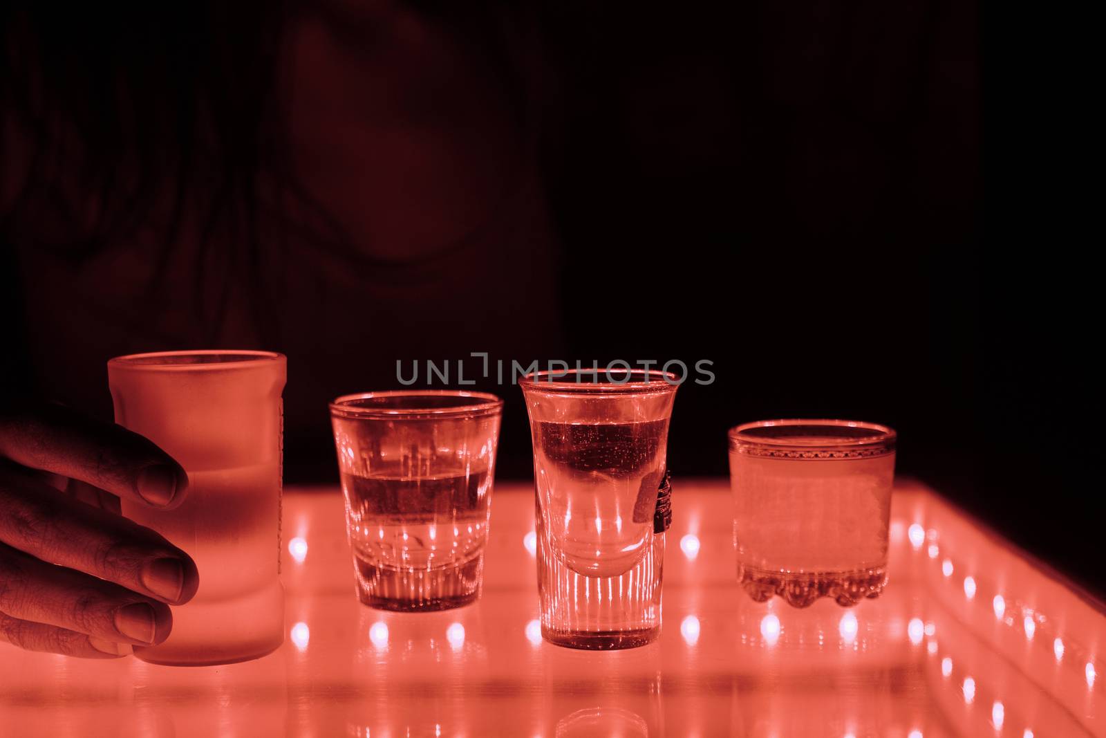 woman in a bar or club with glass of alcohol drink