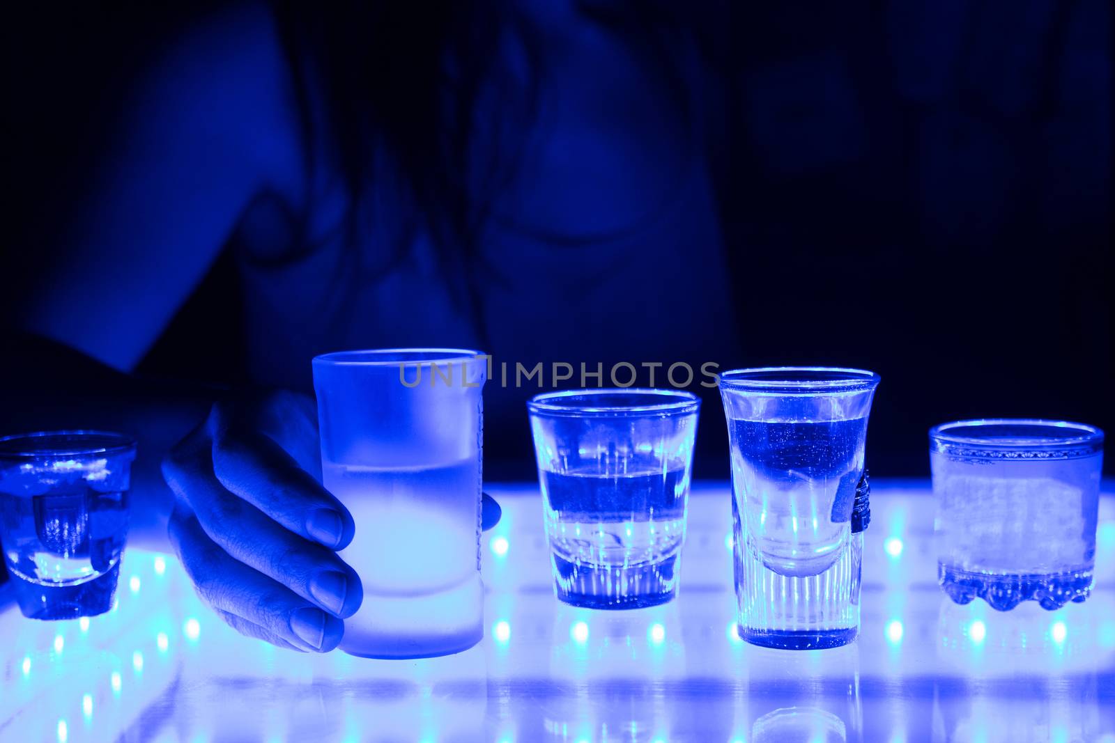 woman in a bar or club with glass of alcohol drink