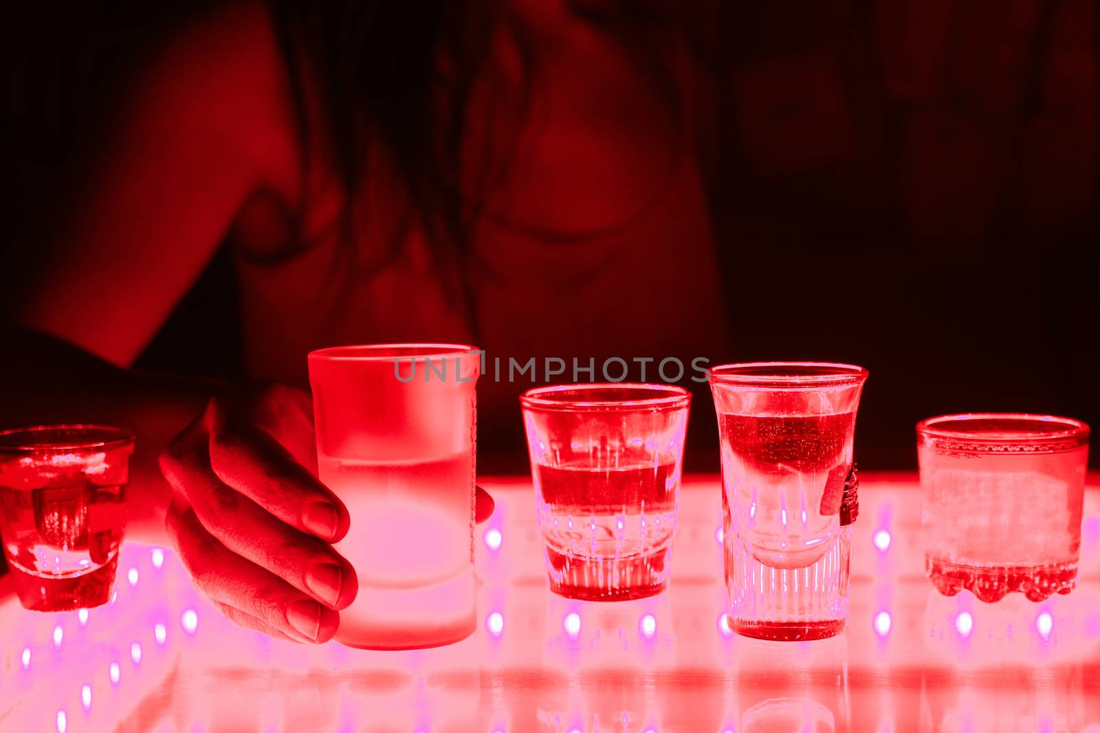 woman in a bar or club with glass of alcohol drink