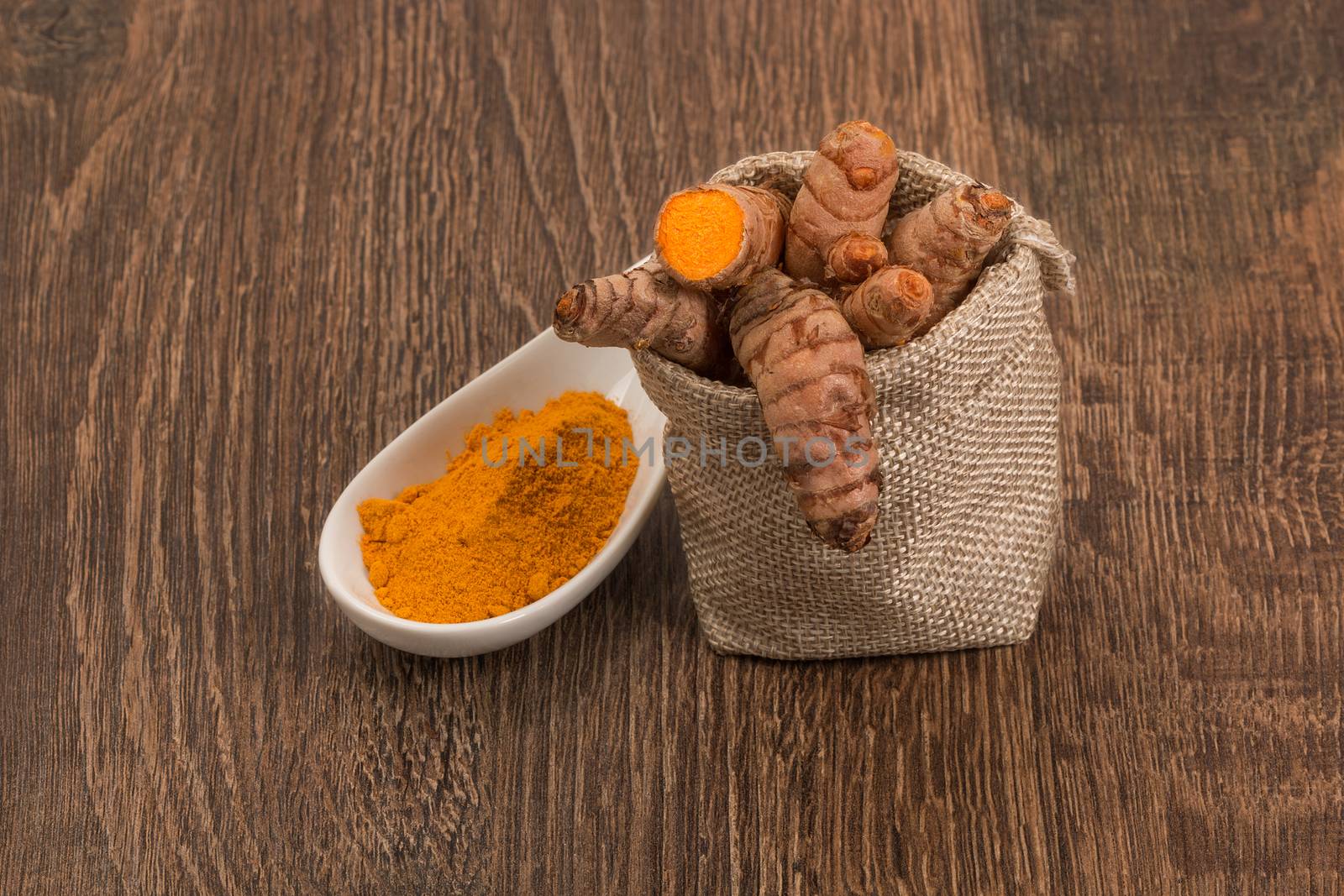 Raw and ground turmeric by ivo_13