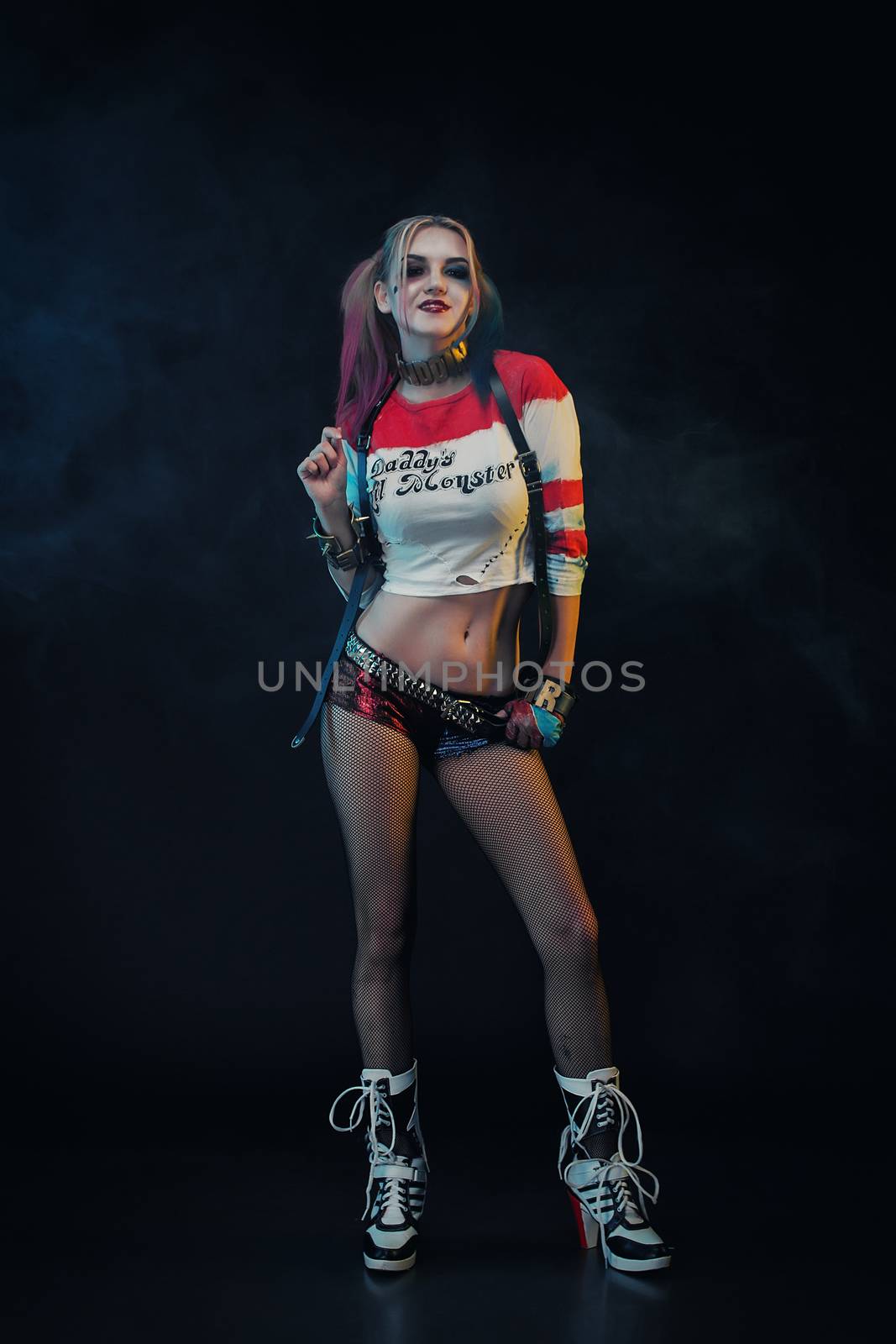 Cosplayer girl with in Harley Quinn costume. Halloween make up by 3KStudio