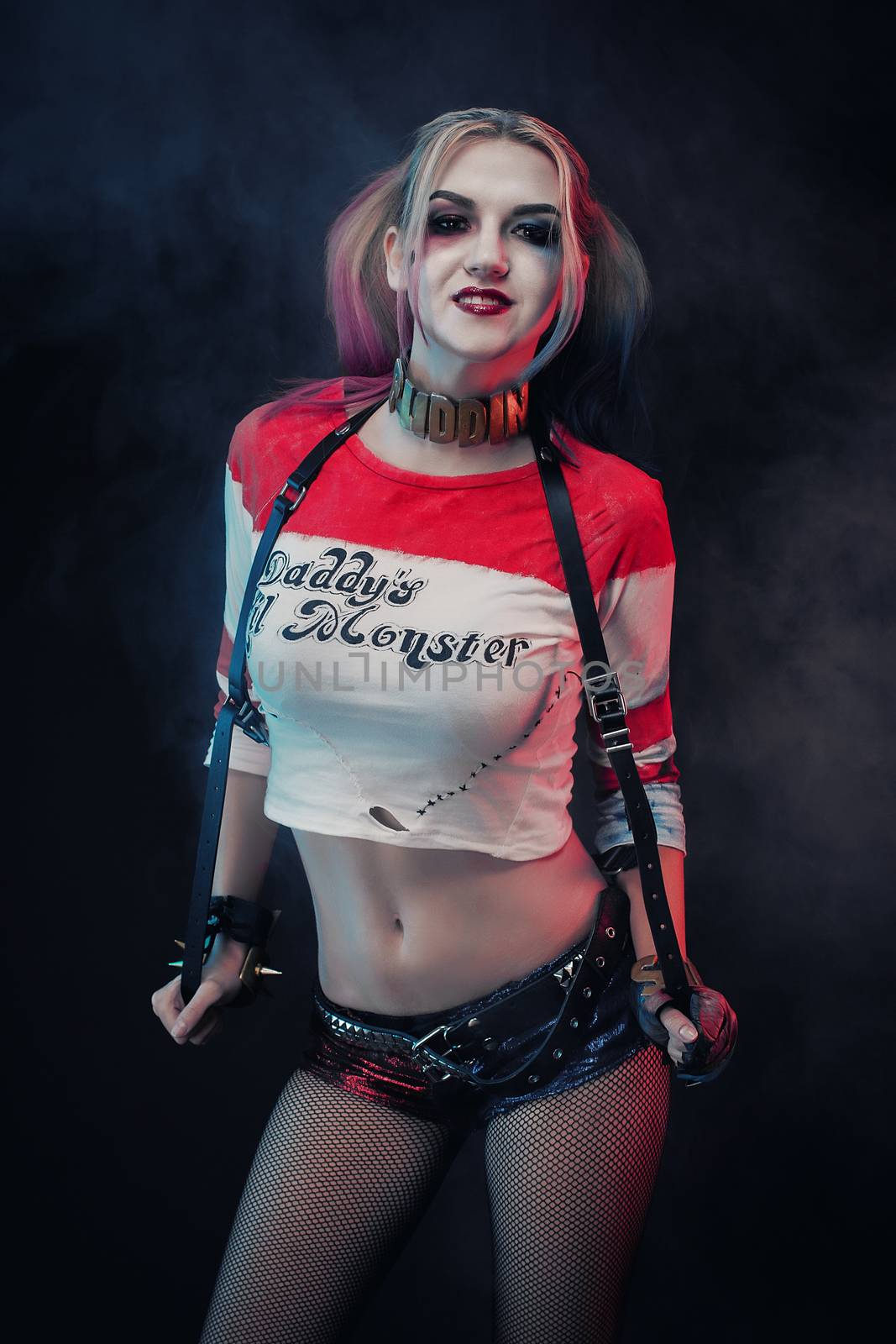 Cosplayer girl with in Harley Quinn costume. Halloween make up by 3KStudio