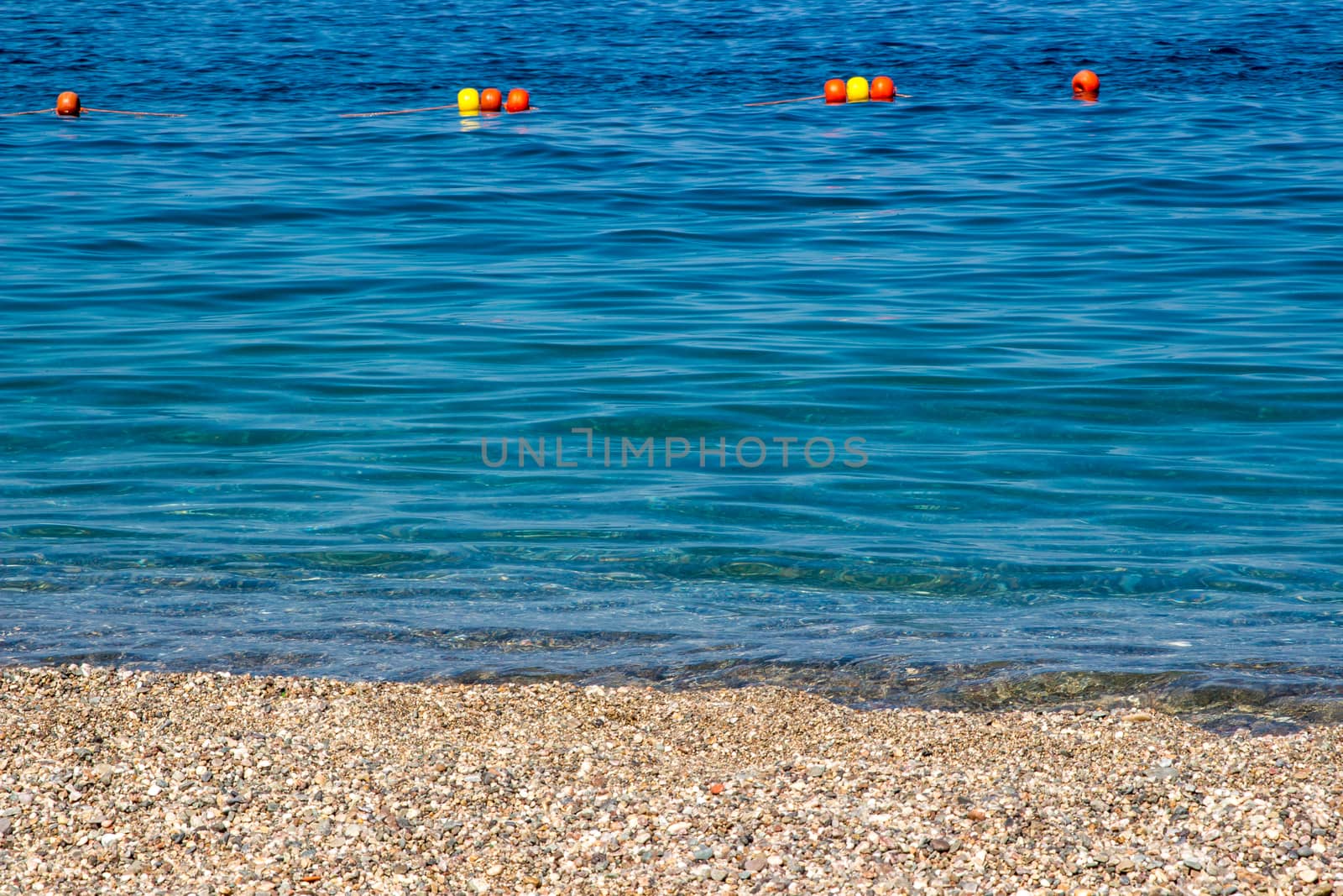 Sand the rocks and a blue Mediterranean sea