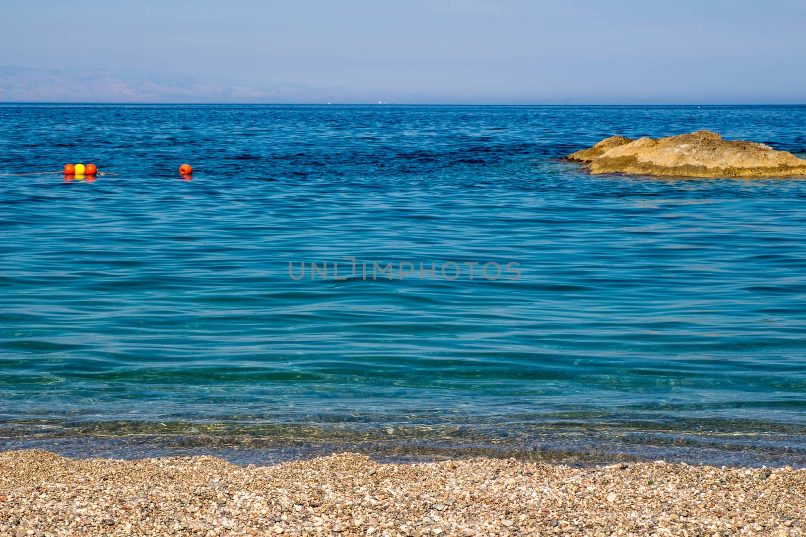 Sand the rocks and a blue Mediterranean sea