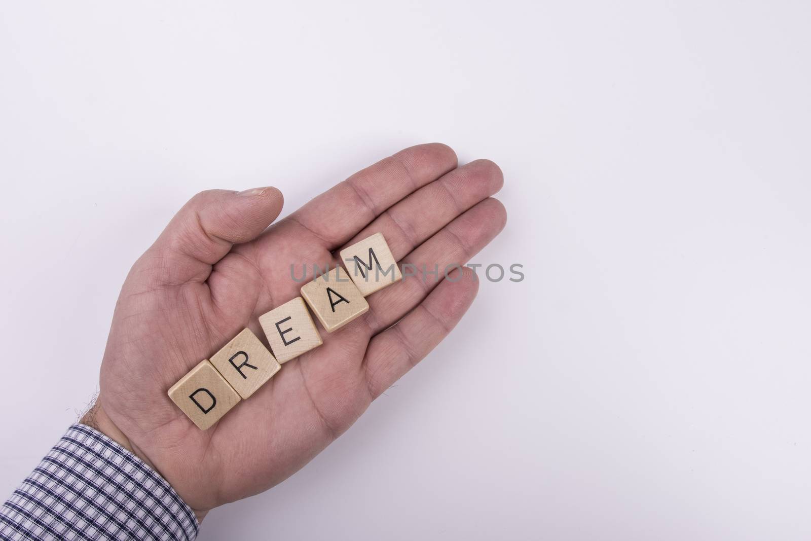 the word "dream" written with letters written on wooden blocks