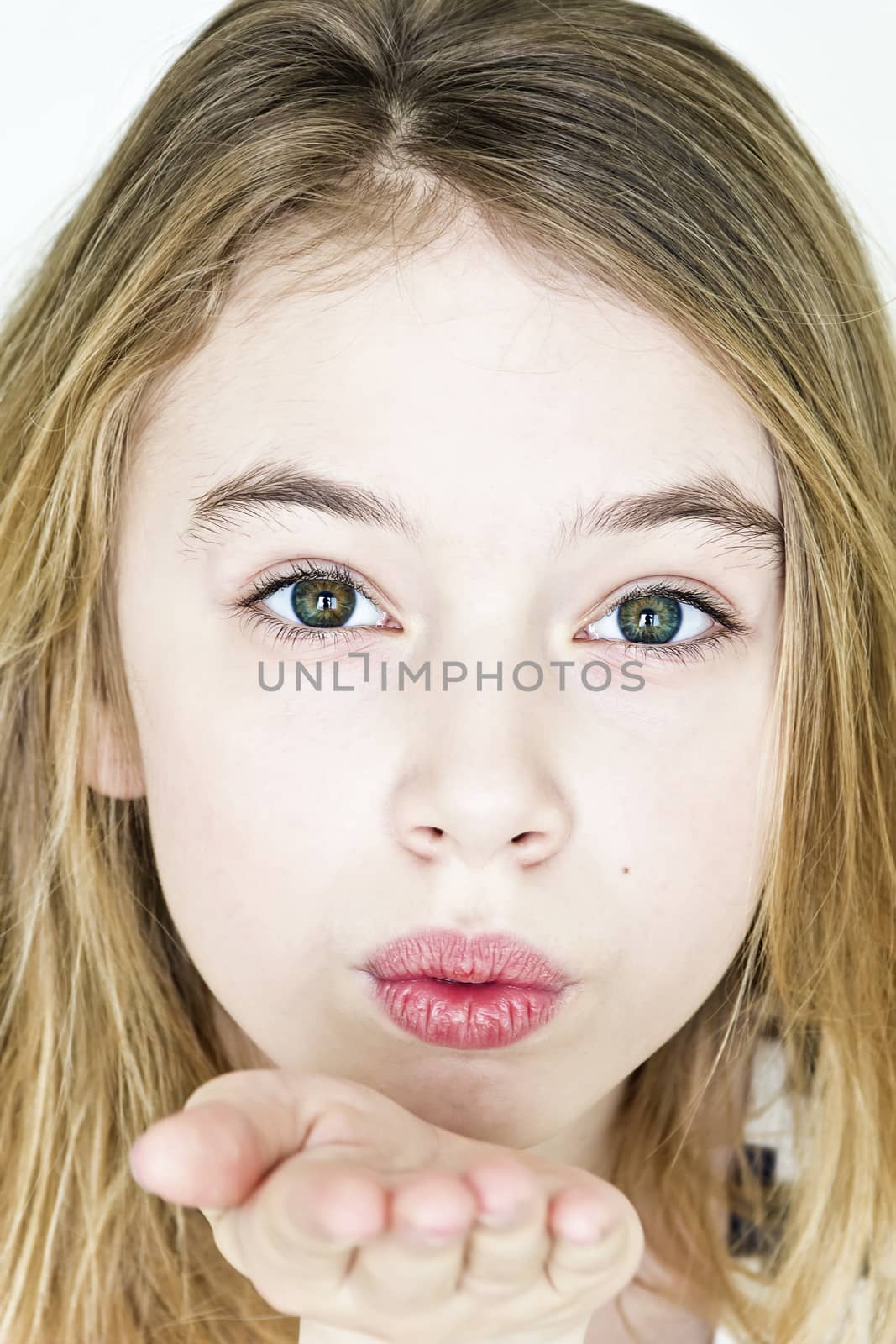 Girl with blond hair and big green eyes on white are sending air kiss