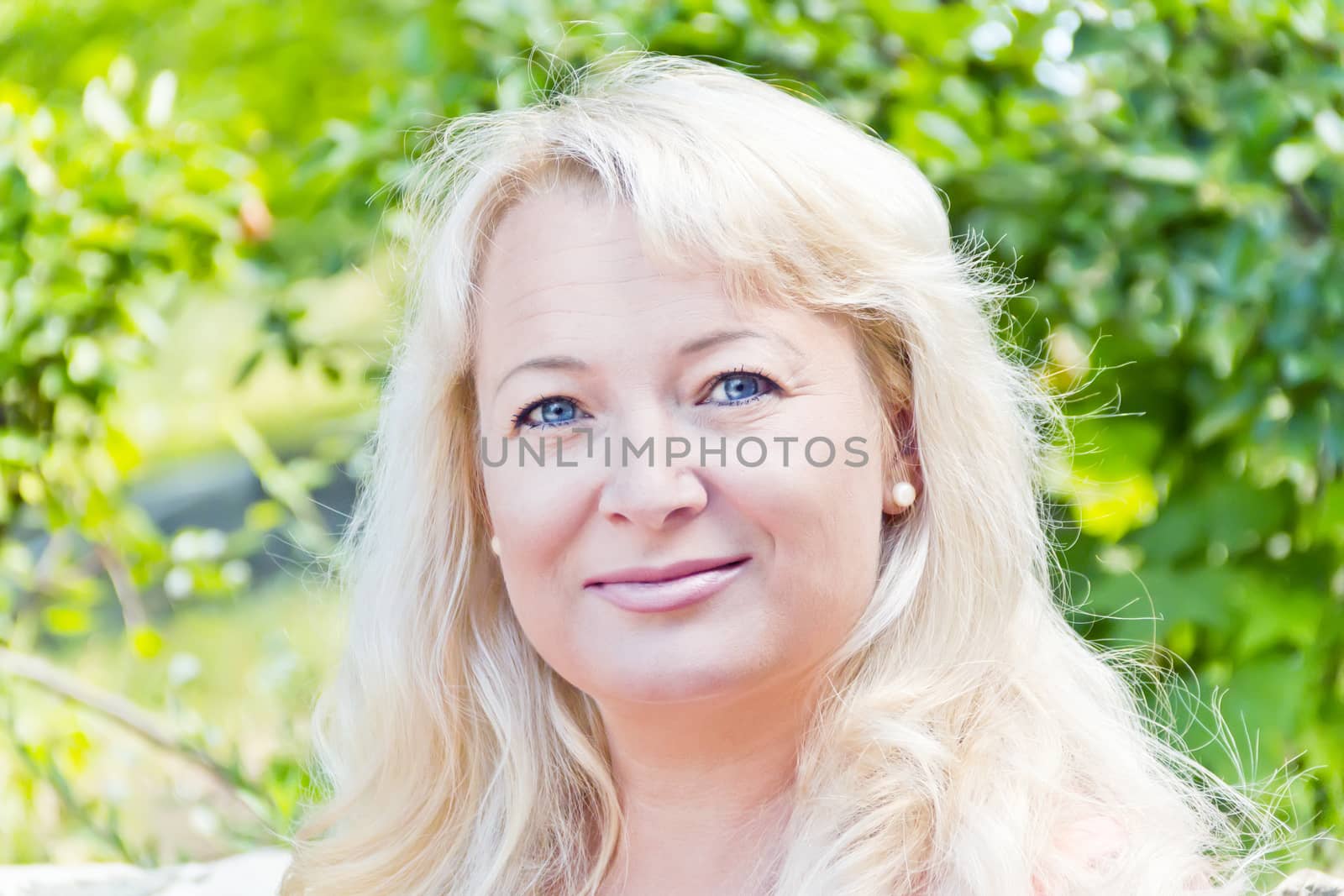 Portrait of blond woman with sapphirine eyes