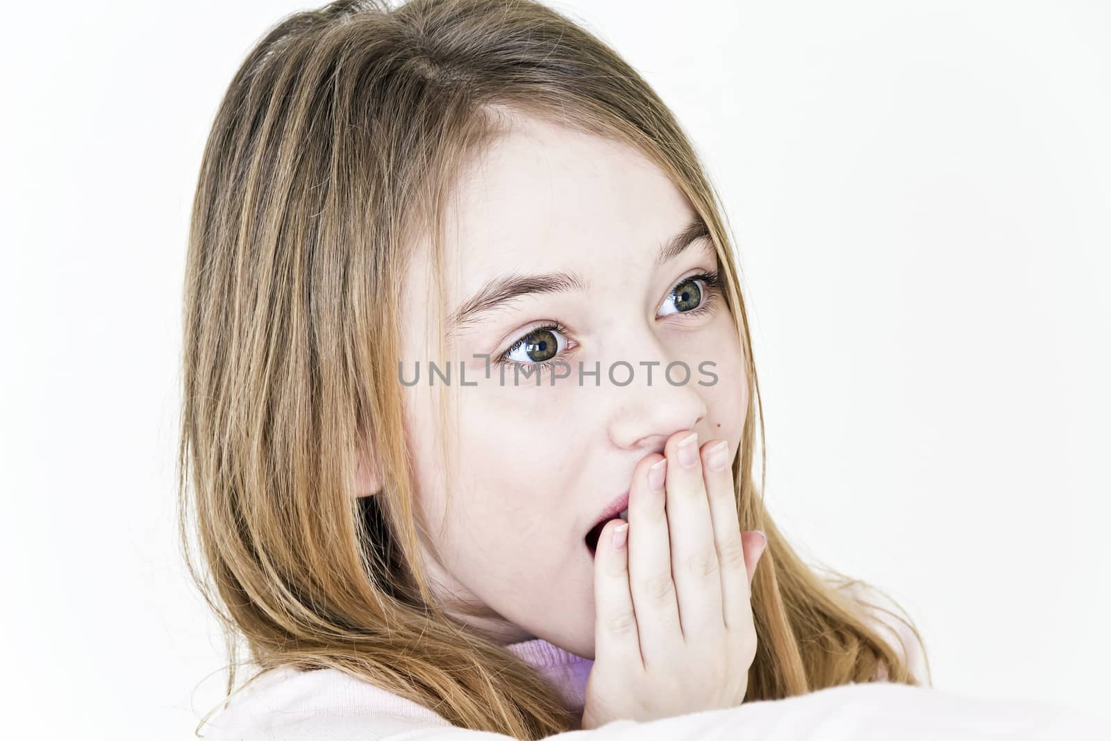 Beautiful surprised girl with long blond hair on white