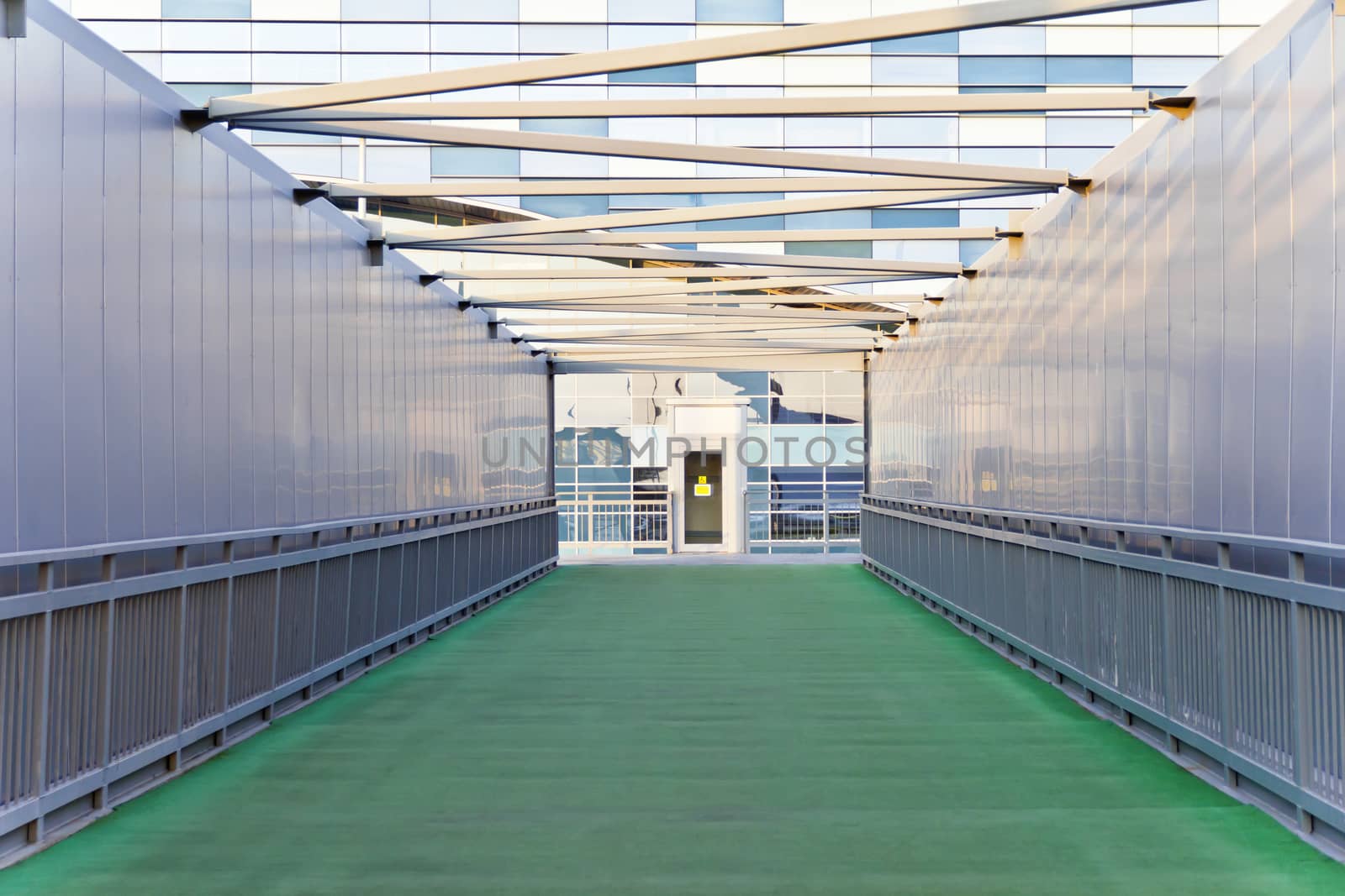 Green corridor of modern building by Julialine