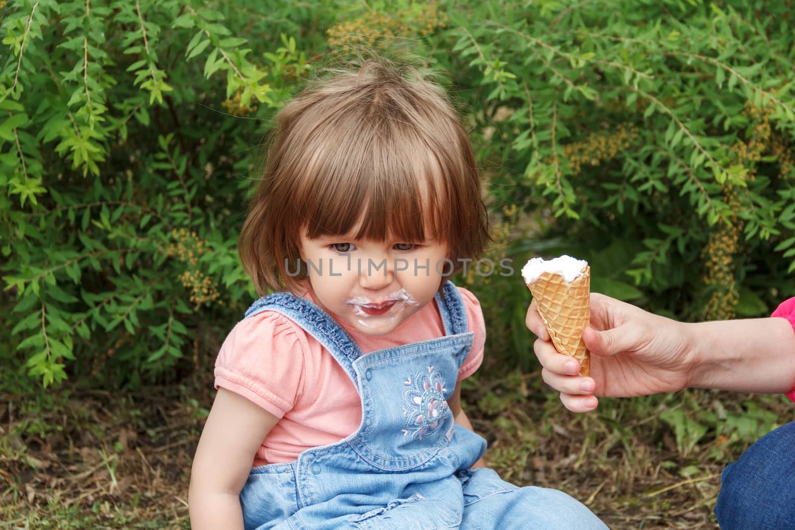 Cute girl with icecream mouth in summer by Julialine