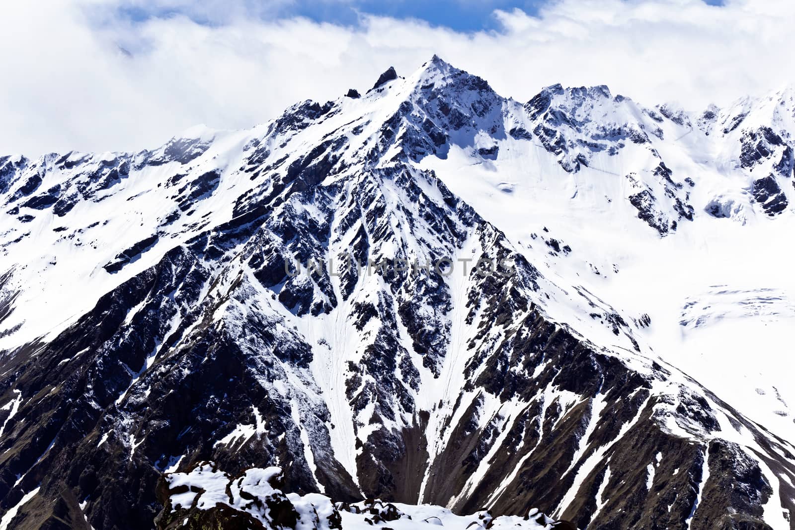 Caucasus mountains under fluffy snow by Julialine