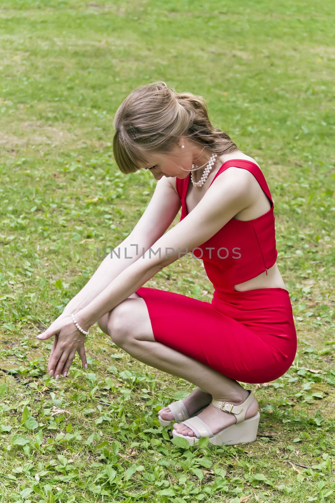 Lady in red are sitting on squat
