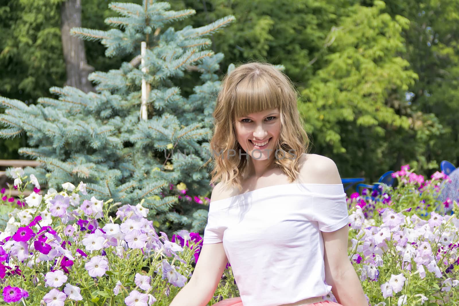 Horizontal portrait of young smiling woman on flowers background