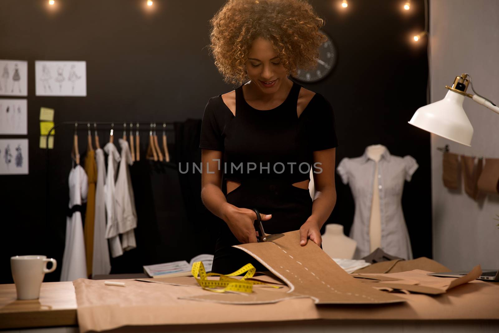 A young fashion designer working on her atelier