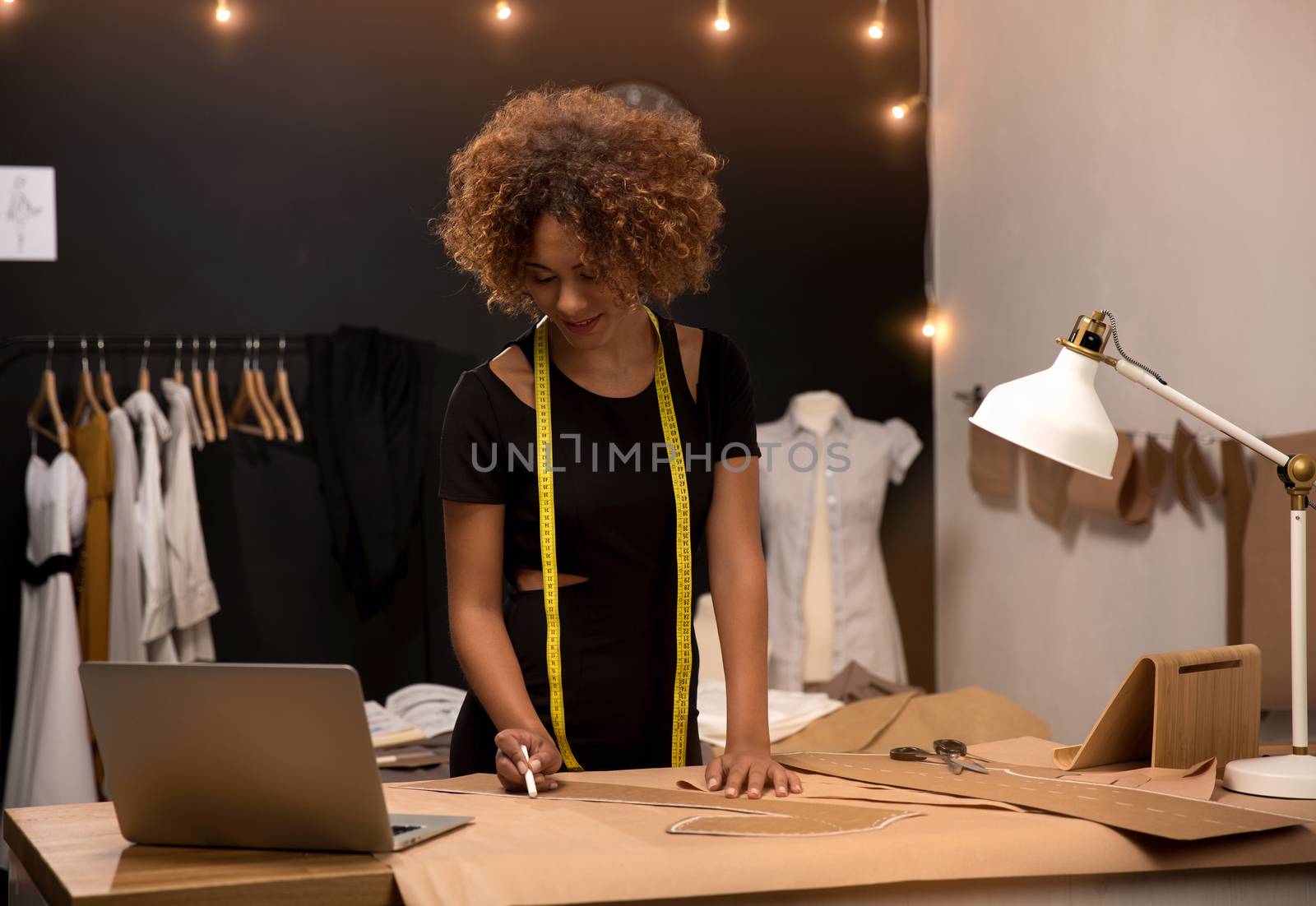 A young fashion designer working on her atelier