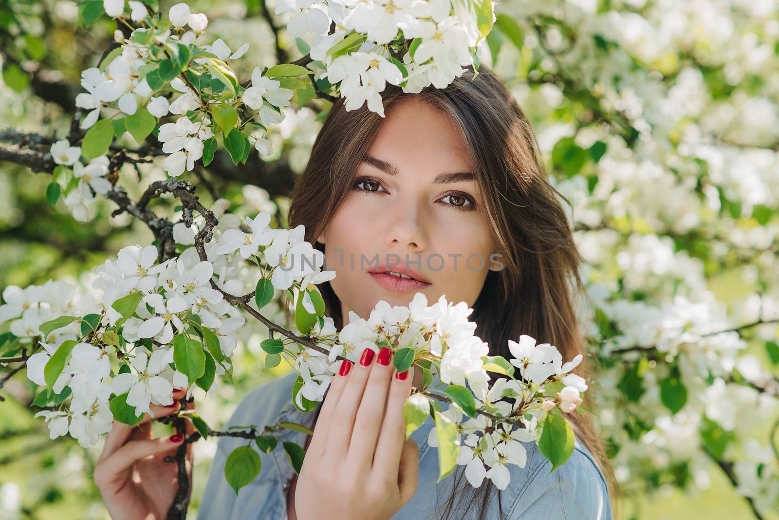 Woman near blooming apple tree by ALotOfPeople