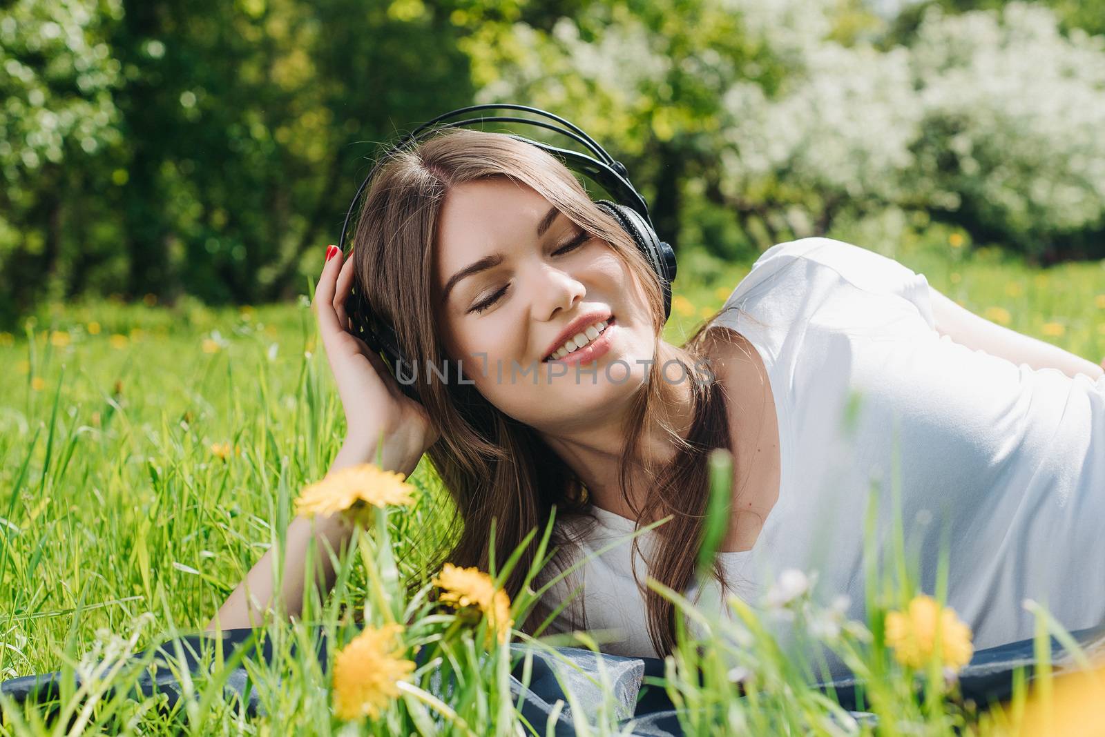 Woman listening music outdoors by ALotOfPeople