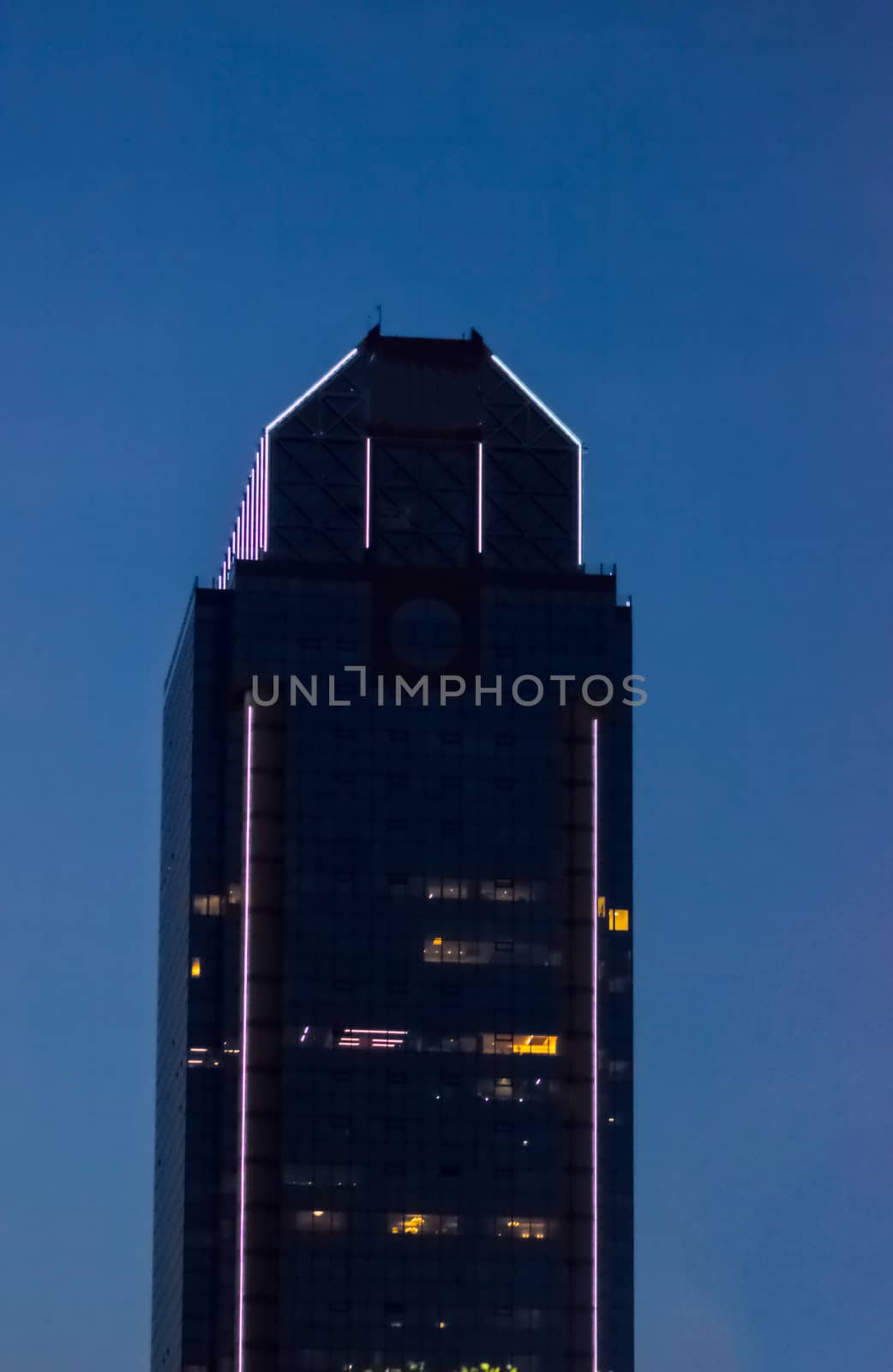 top part of the glass office building during the evening time