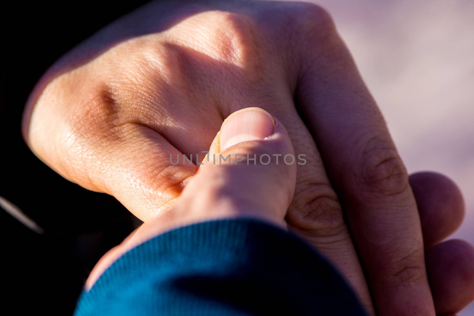 boyfriend and girlfriend holding hands together while they are walking